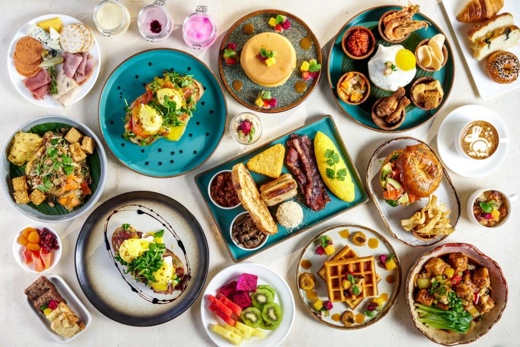 a table with plates of food on it at Holiday Inn Resort Bali Canggu by IHG in Canggu