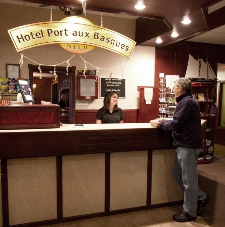 two people standing at a hotel port aux basques counter at Hotel Port Aux Basques in Channel-Port aux Basques