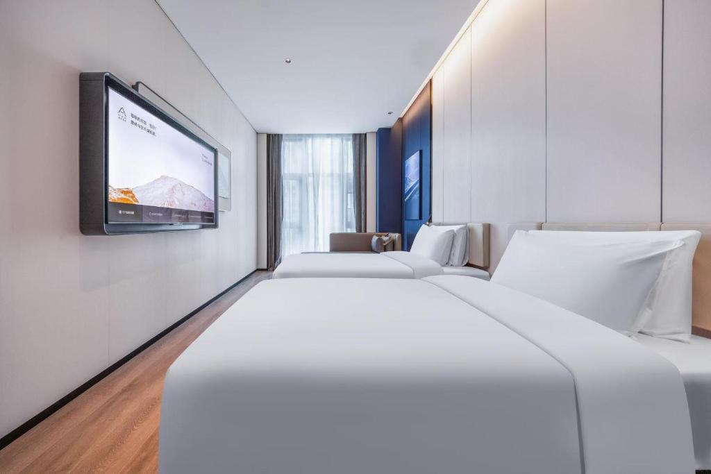 Postel nebo postele na pokoji v ubytování Atour Hotel Dongguan Xiping Xindi Center