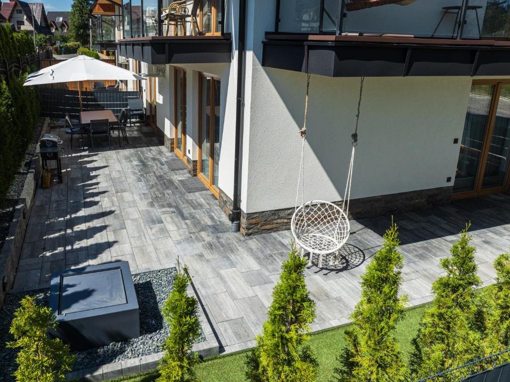 an overhead view of a patio with a swing at Apartamenty Księżycowe SPA - Tatra View - Golden Apartments in Zakopane