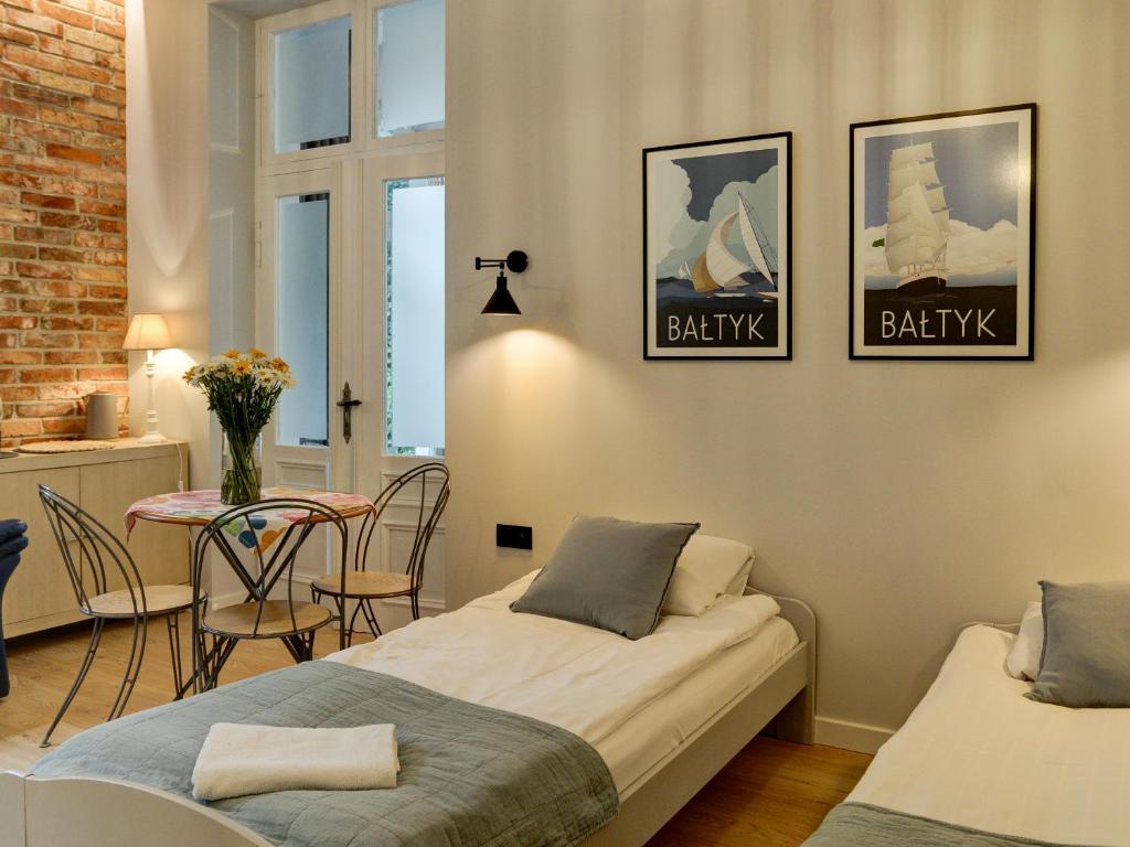 Postel nebo postele na pokoji v ubytování Kamienica Ogrodowa Rooms