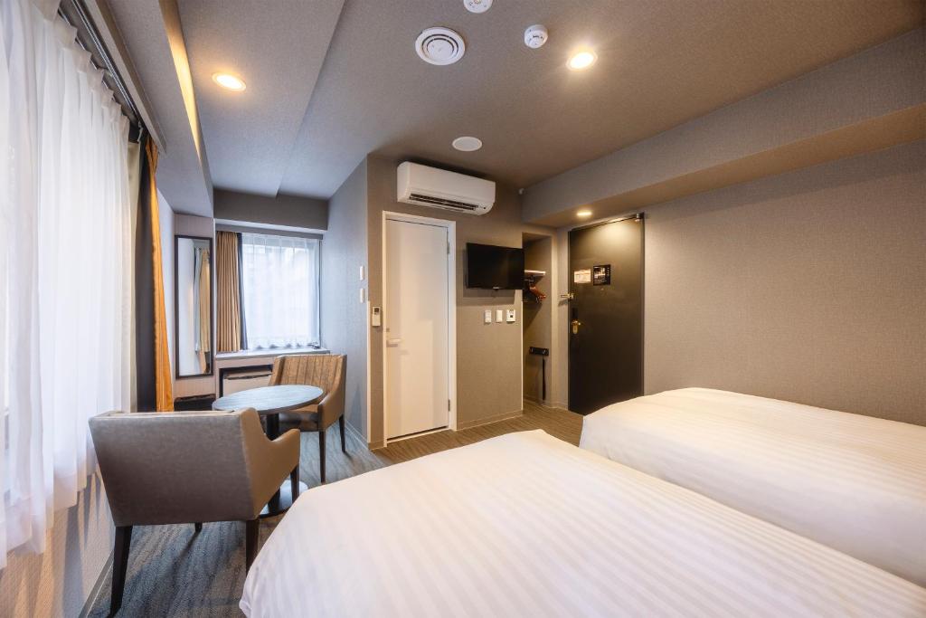 Postel nebo postele na pokoji v ubytování Hotel Wing International Shimbashi Onarimon