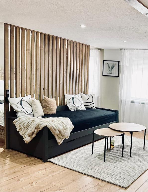 a bedroom with a large bed with two tables at 1 - 4 Pers Apartment Jeßnitz, Mawoi Living in Jeßnitz