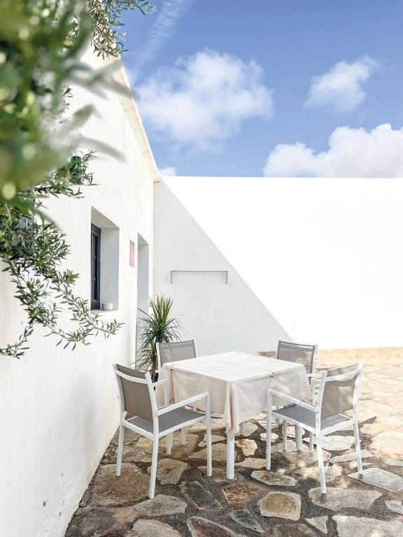 a white table and chairs on a patio at Casa Picón in Tinajo
