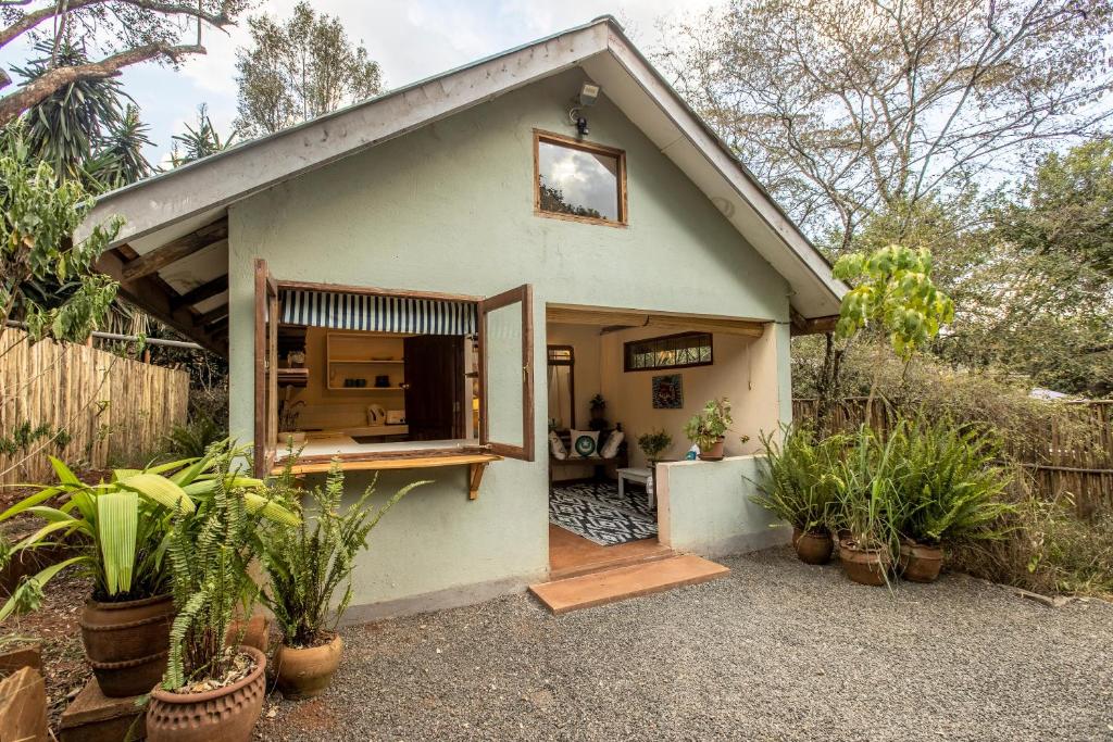 a small house with plants in front of it at Ol Losowan House and Cottages in Nairobi