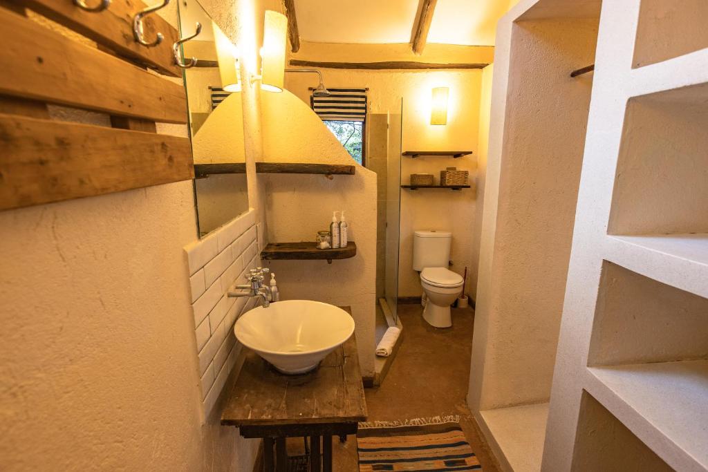 a bathroom with a sink and a toilet at Ol Losowan House and Cottages in Nairobi