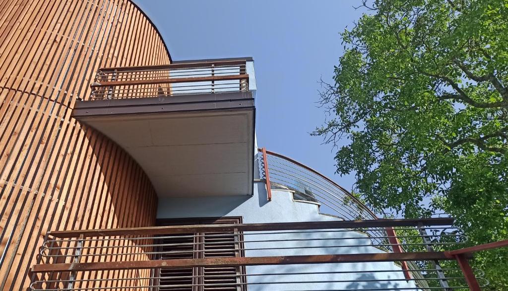 a building with a spiral staircase on the side of it at La Terrazza delle Noci - alloggio agrituristico in Lioni