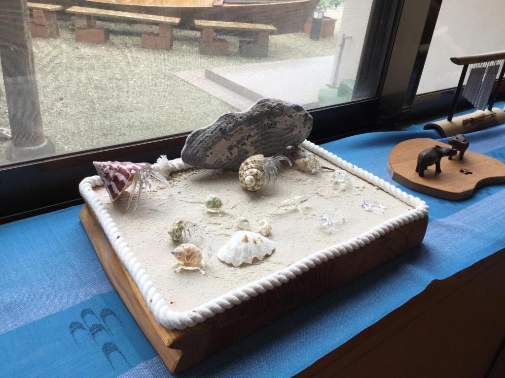 a cake sitting on a table next to a window at Joya in Ishigaki Island