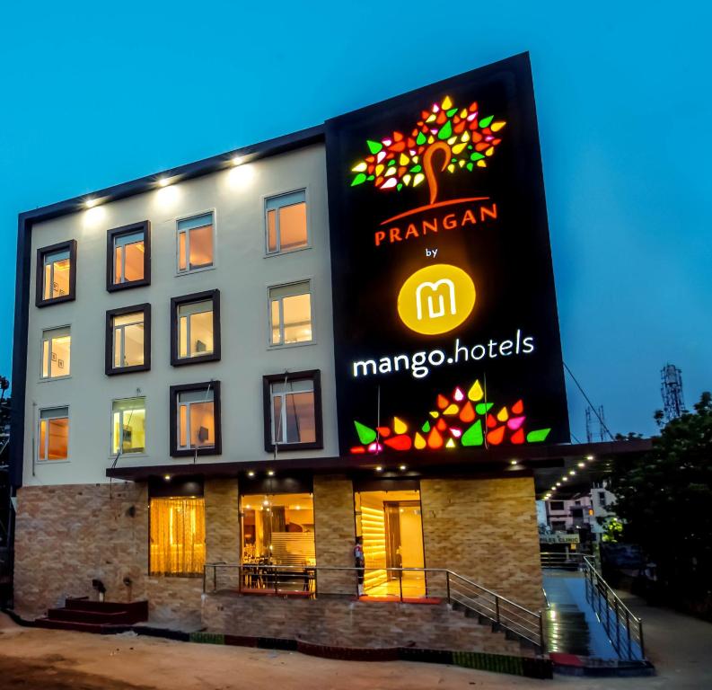 a building with a large sign on the side of it at Mango Hotels Prangan in Bhubaneshwar