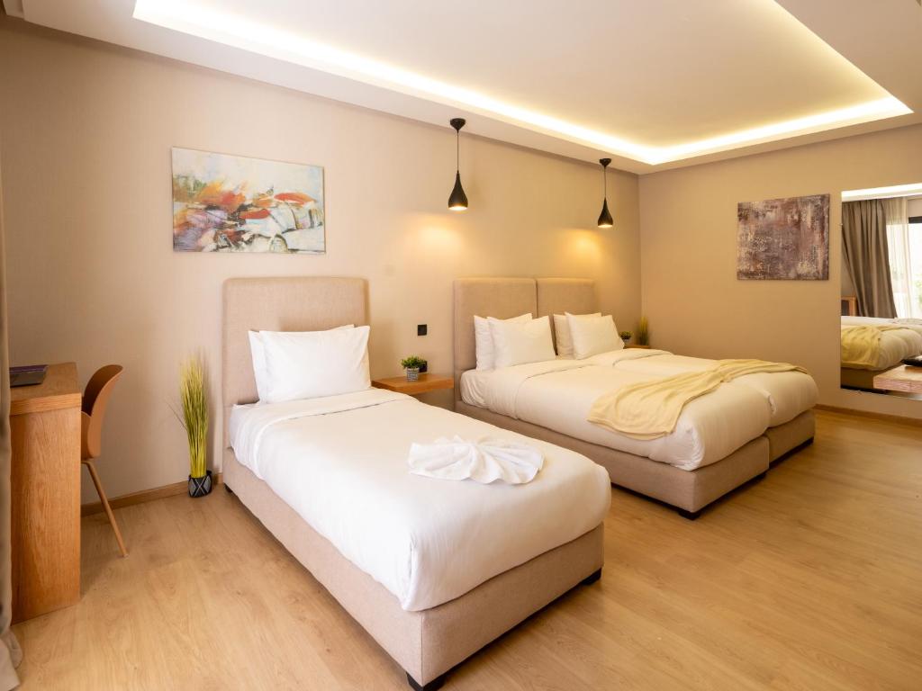 Postel nebo postele na pokoji v ubytování Unico Hotel Maarif