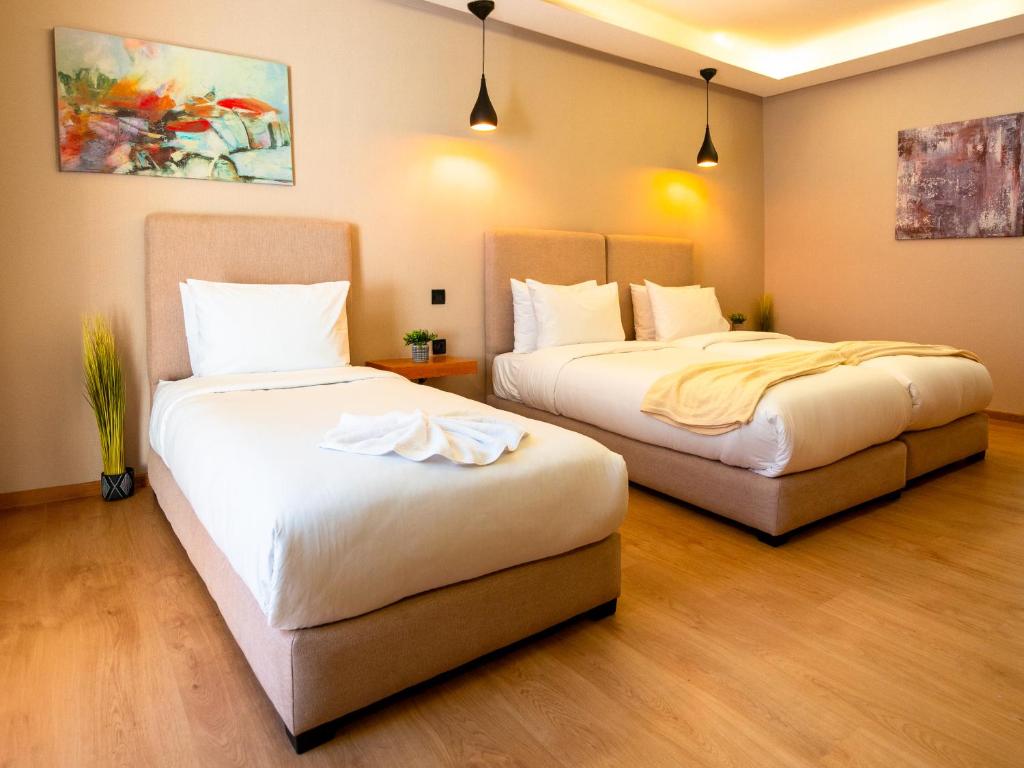 Postel nebo postele na pokoji v ubytování Unico Hotel Maarif