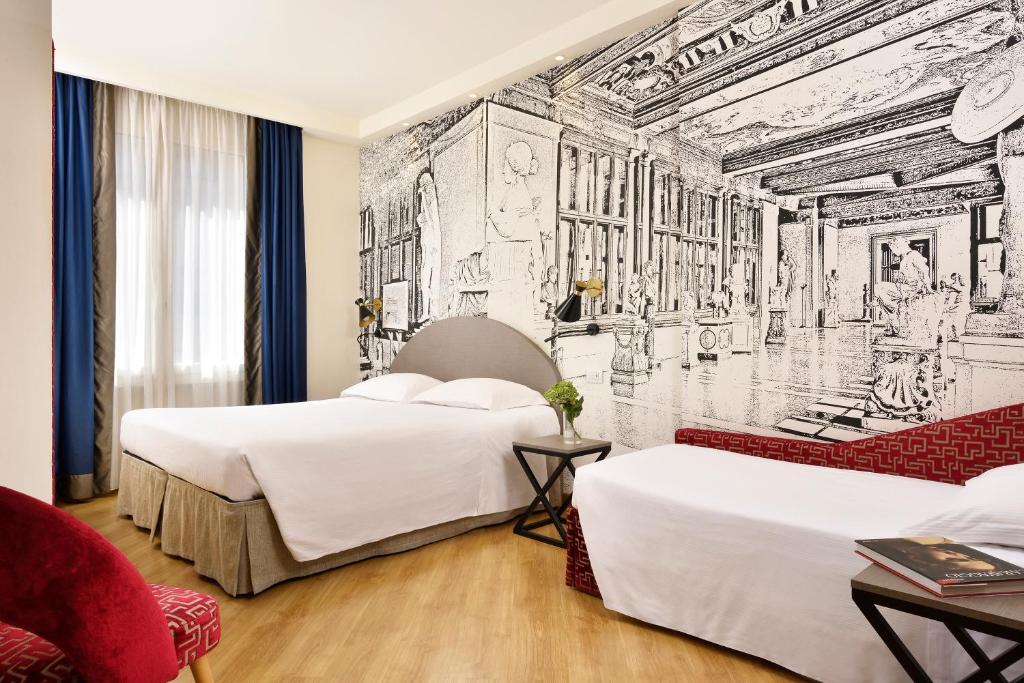 A bed or beds in a room at FH55 Grand Hotel Mediterraneo