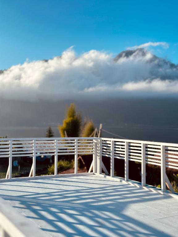 a white boardwalk with a mountain in the background at EL Diabloo Camp in Kubupenlokan