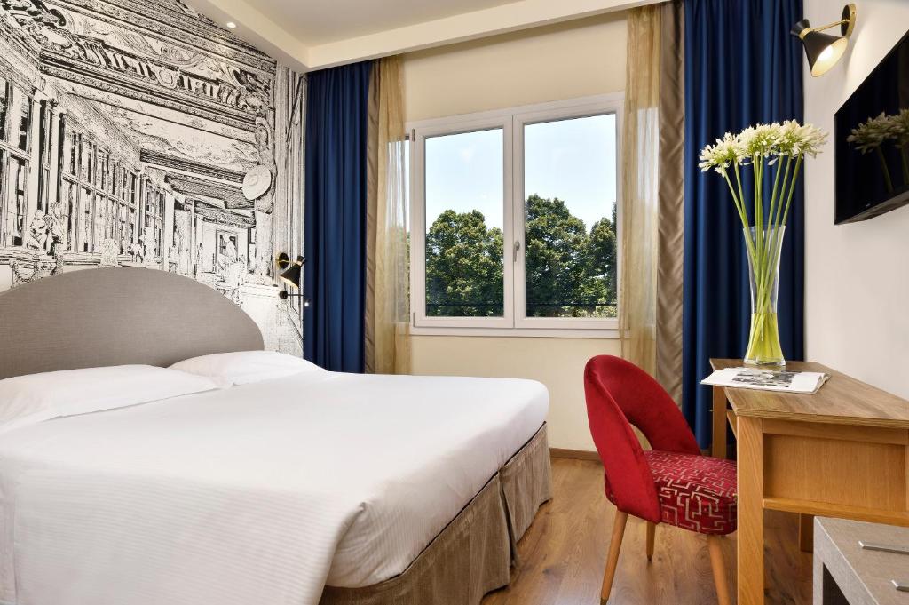 A bed or beds in a room at FH55 Grand Hotel Mediterraneo