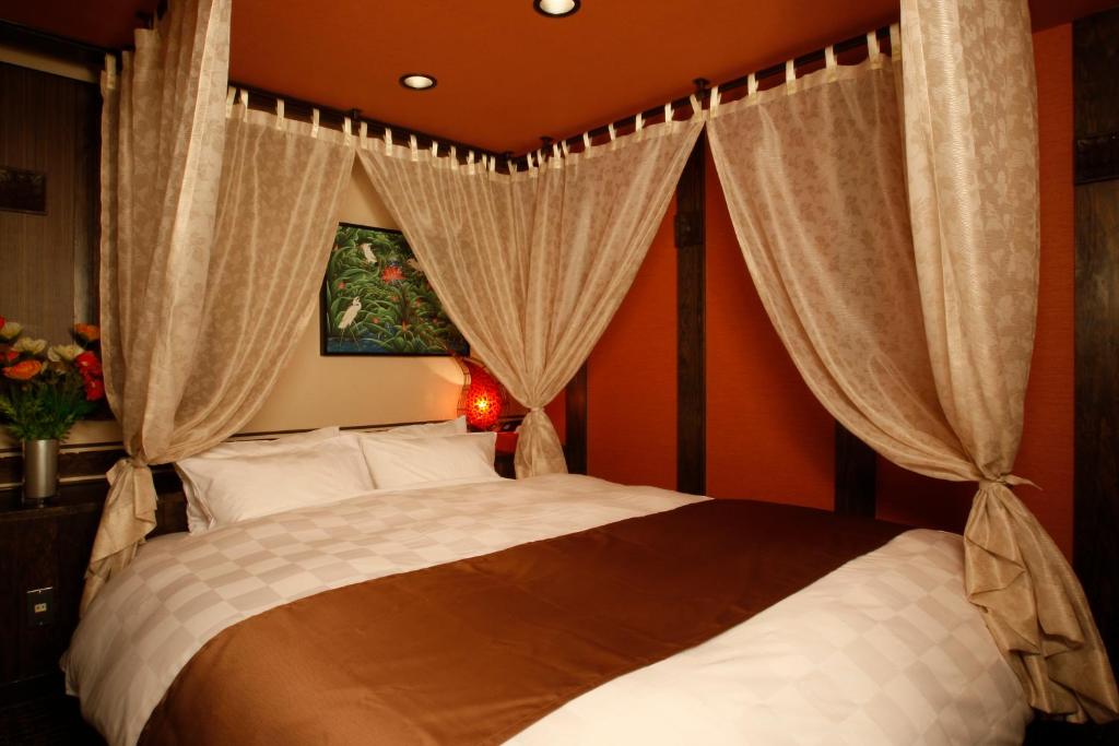 Ένα ή περισσότερα κρεβάτια σε δωμάτιο στο HOTEL K's ABA Adult Only