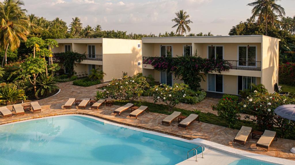 an aerial view of a resort with a swimming pool at Maharaja Boutique Hotel Zanzibar in Uroa