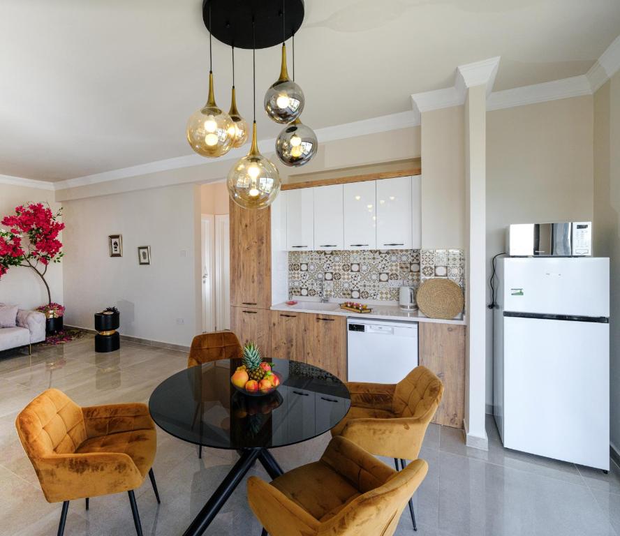 a kitchen and dining room with a table and chairs at Starlight Terrace PENTHOUSE in Marmara