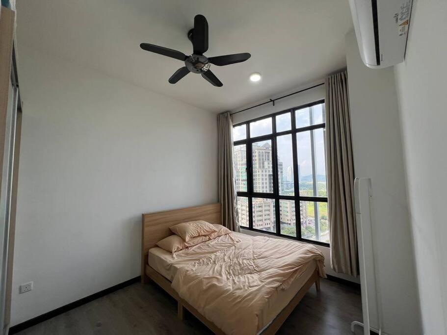 a bedroom with a bed and a ceiling fan at Fify Homestay in Putrajaya