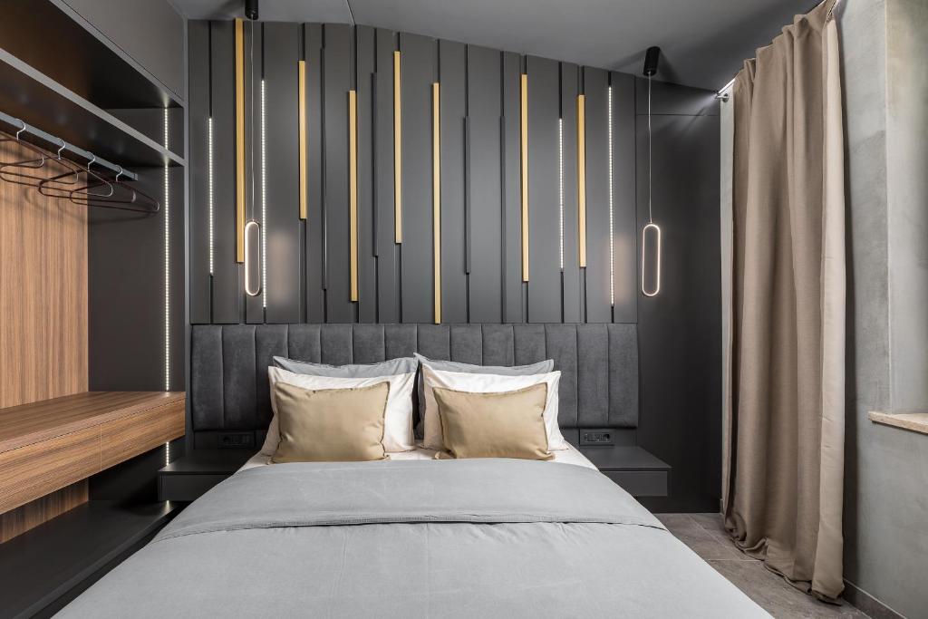 a bedroom with a bed with a black headboard at Center Apartments BAG, With PRIVATE FREE PARKING in Pula