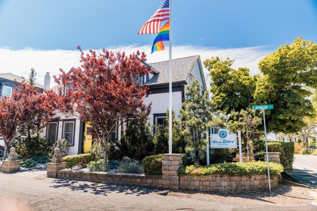 a house with an american flag on a street at Ellery Hotel Provincetown in Provincetown