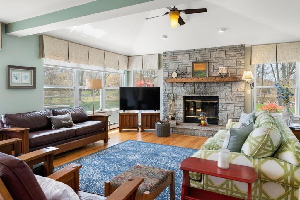 a living room with a couch and a fireplace at 37 Wamphassuc Rd Chteau Stonington in Stonington