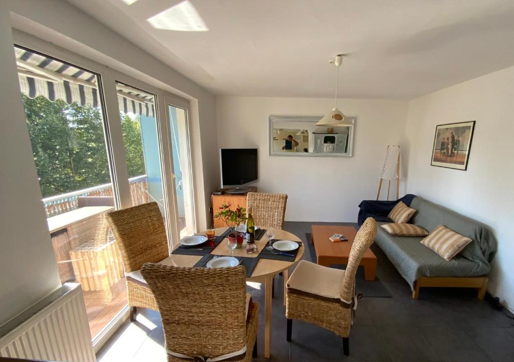 a living room with a couch and a table at Luminous apartment in Kehl near Strasbourg, conveniently located next to a tram stop with direct access to Strasbourg city centre in Kehl am Rhein