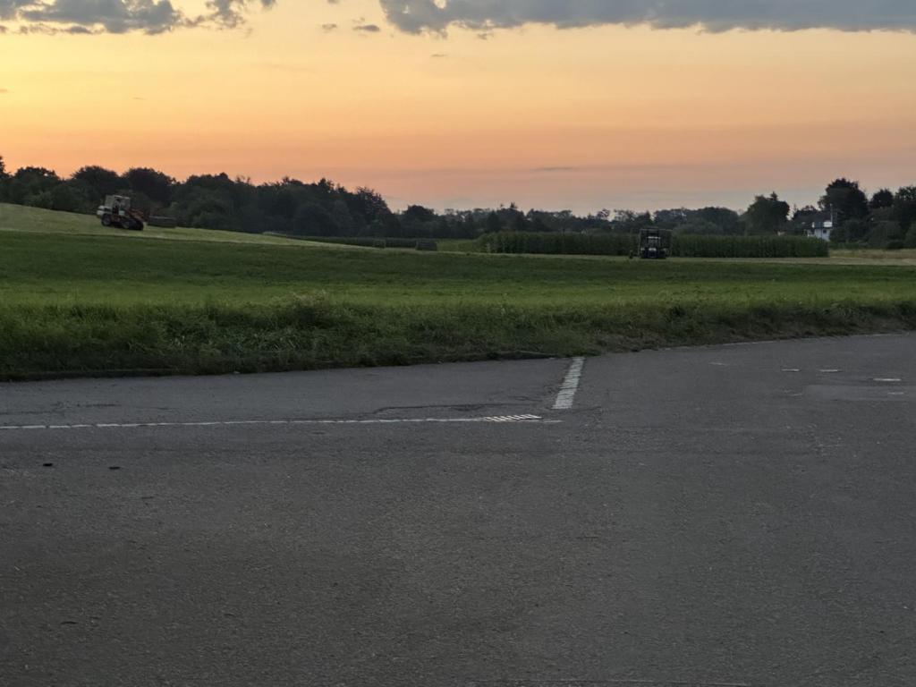 an empty road with a field in the background at Tulpe in Günzburg