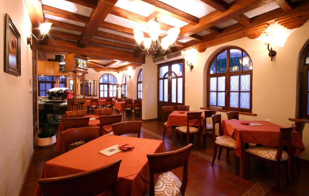 a restaurant with tables and chairs in a room at Panonija in Kotor
