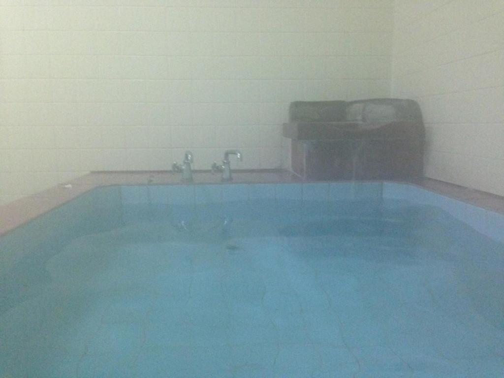 a swimming pool with blue water in a room at Koizumiya - Vacation STAY 14238v in Yuzawa