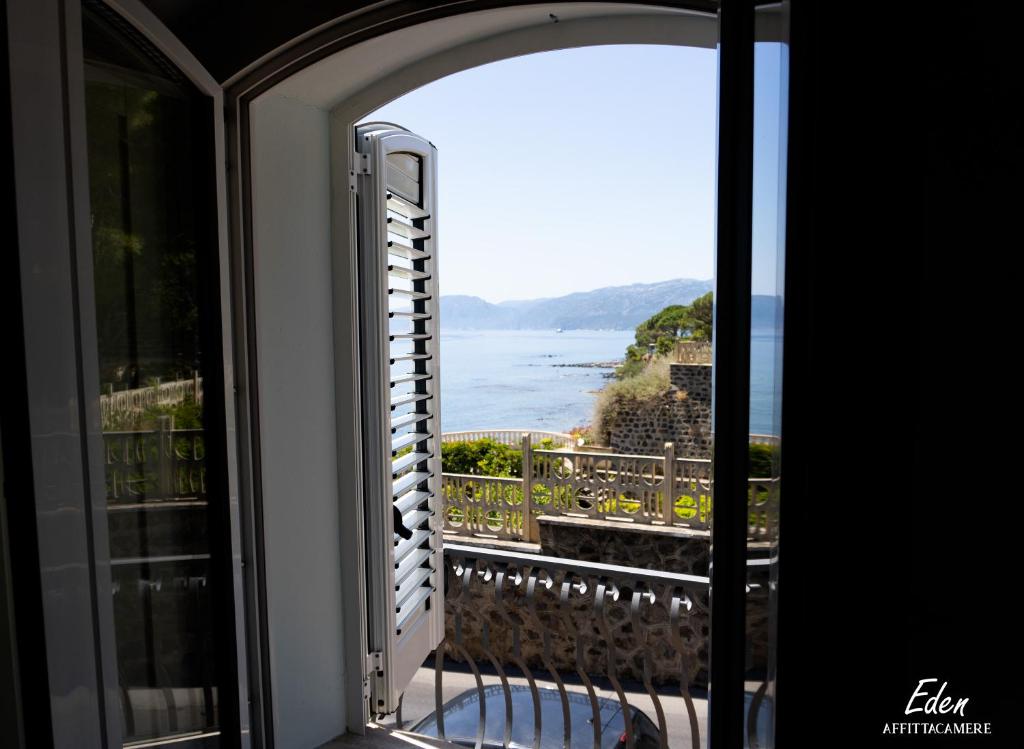 an open window with a view of the ocean at Eden affittacamere in Cala Gonone