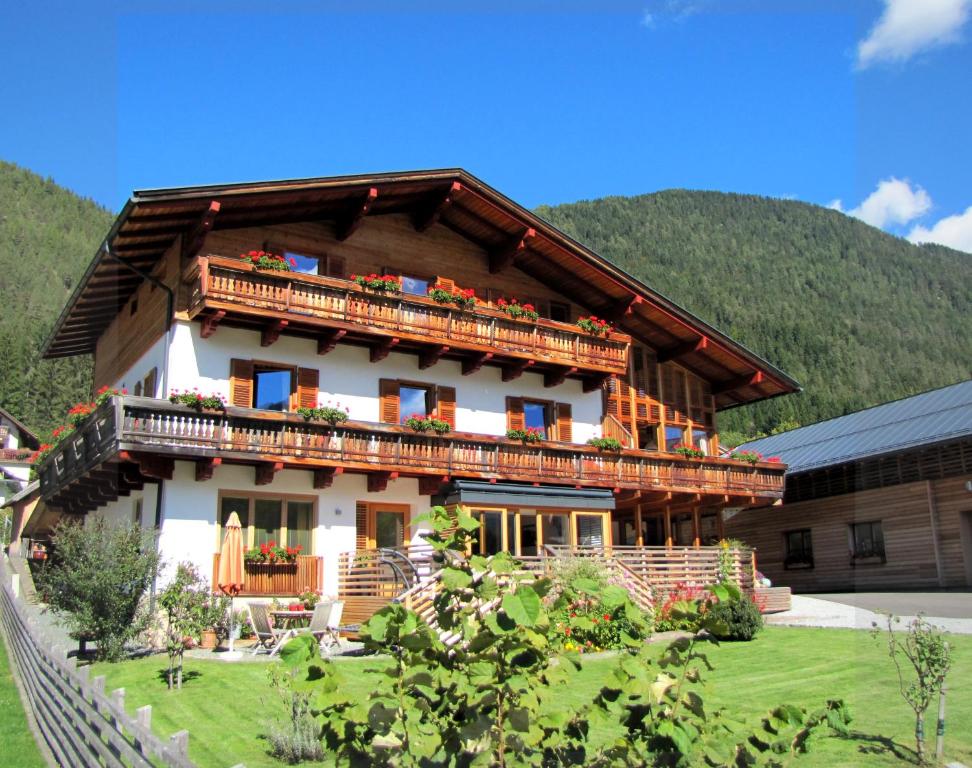 a house with balconies on the side of it at Haus am Mühlbach in Weissensee