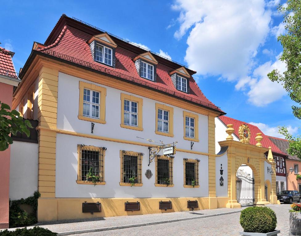 ein großes weißes Gebäude mit rotem Dach in der Unterkunft Romantik Hotel Zehntkeller in Iphofen