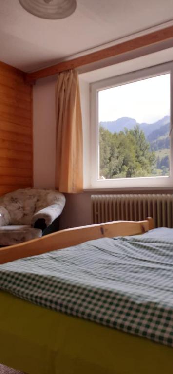 a bedroom with a bed and a window at Apartmán Siná in Lazisko