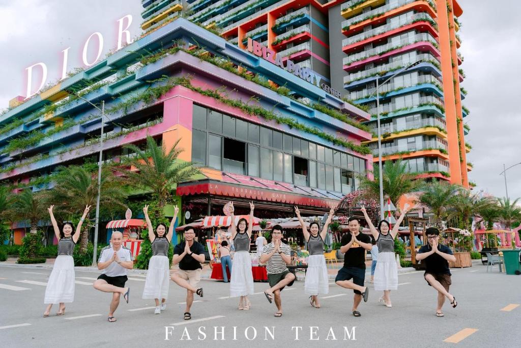 a group of women dancing in front of a building at Căn hộ Flamingo Hải Tiến in Thanh Hóa