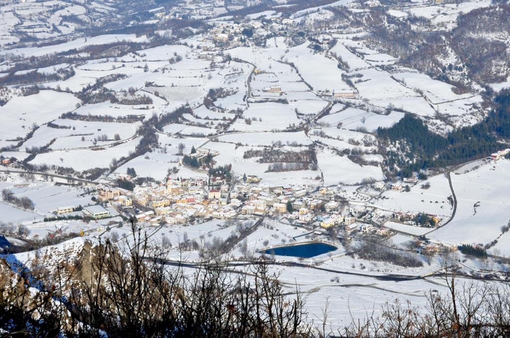 an aerial view of a town in the snow at Tana Degli Orsi in Cantalupo Ligure
