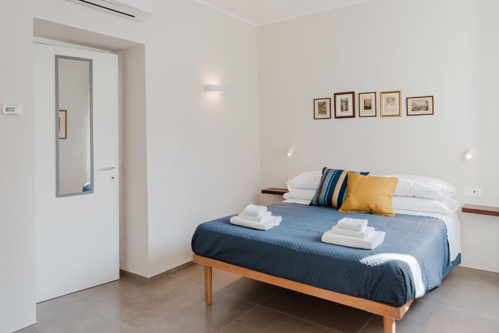 a bedroom with a bed with towels on it at Senape - Menaggio by LoveComo in Menaggio