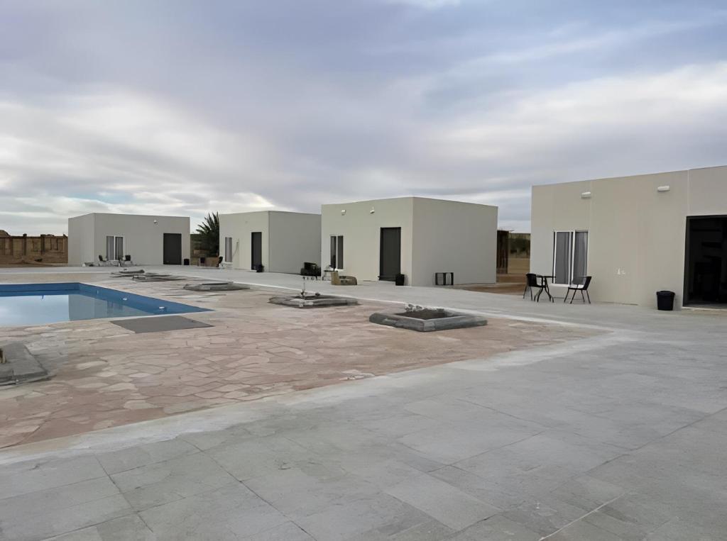 un edificio con piscina in un cortile di Studio overlooking pool amid flowering and quiet a Al Ula