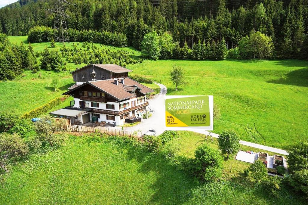 an aerial view of a house in a green field at Fasserhof in Bramberg am Wildkogel