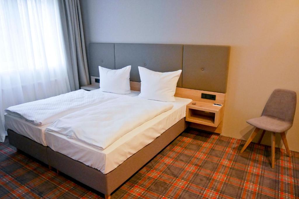 Postel nebo postele na pokoji v ubytování Hotel Alpha