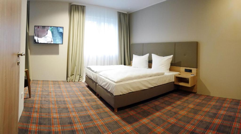 Postel nebo postele na pokoji v ubytování Hotel Alpha