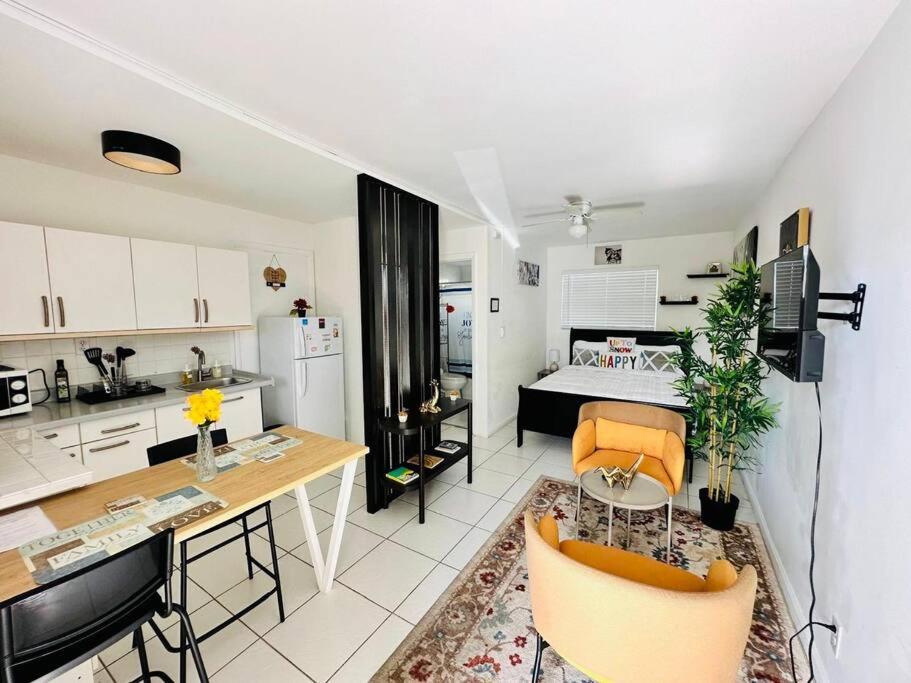 a kitchen and living room with a table and a kitchen and a living room at Cozy apartment near Seminole Hard Rock Cafe in Hollywood