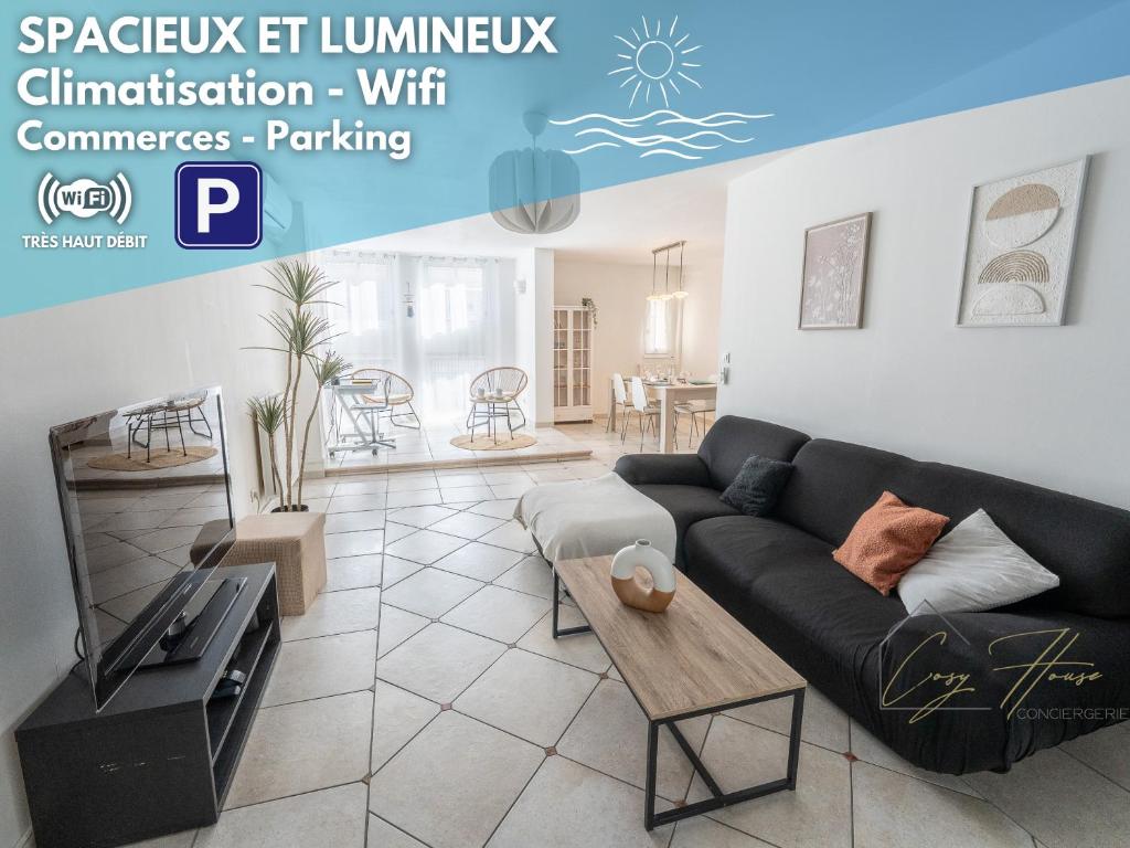 a living room with a couch and a table at Les Salins * Appartement * Clim * Wifi * Commerces in Fos-sur-Mer