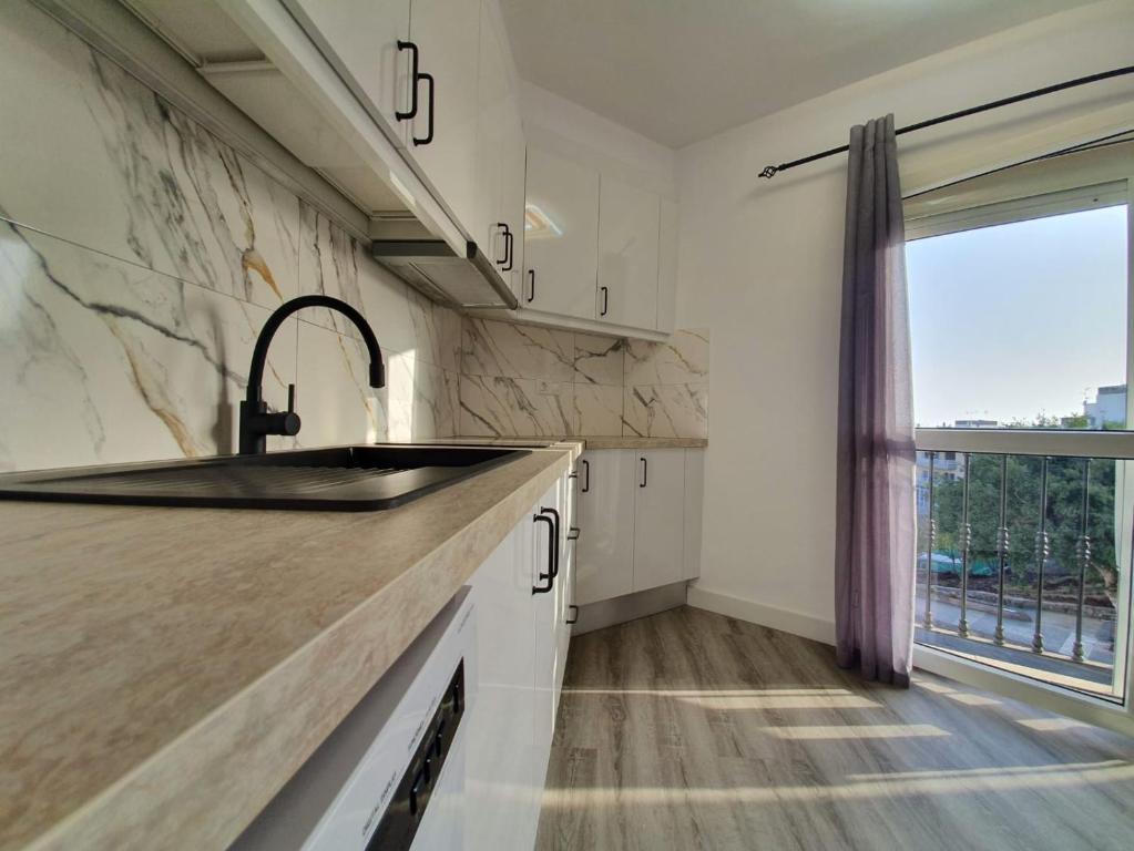 a kitchen with a sink and a window at CASA ALAIA in Arguineguín