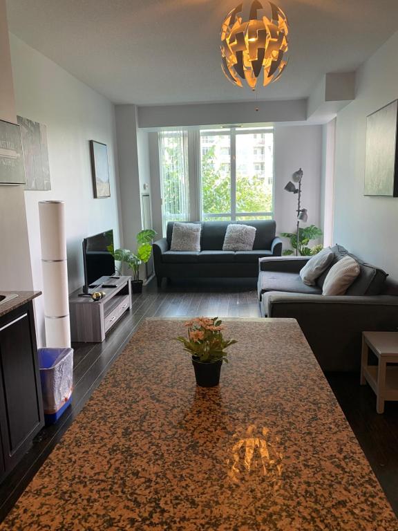 a living room with a couch and a table at Executive 1 Bedroom Condo sleeps 2 in Toronto