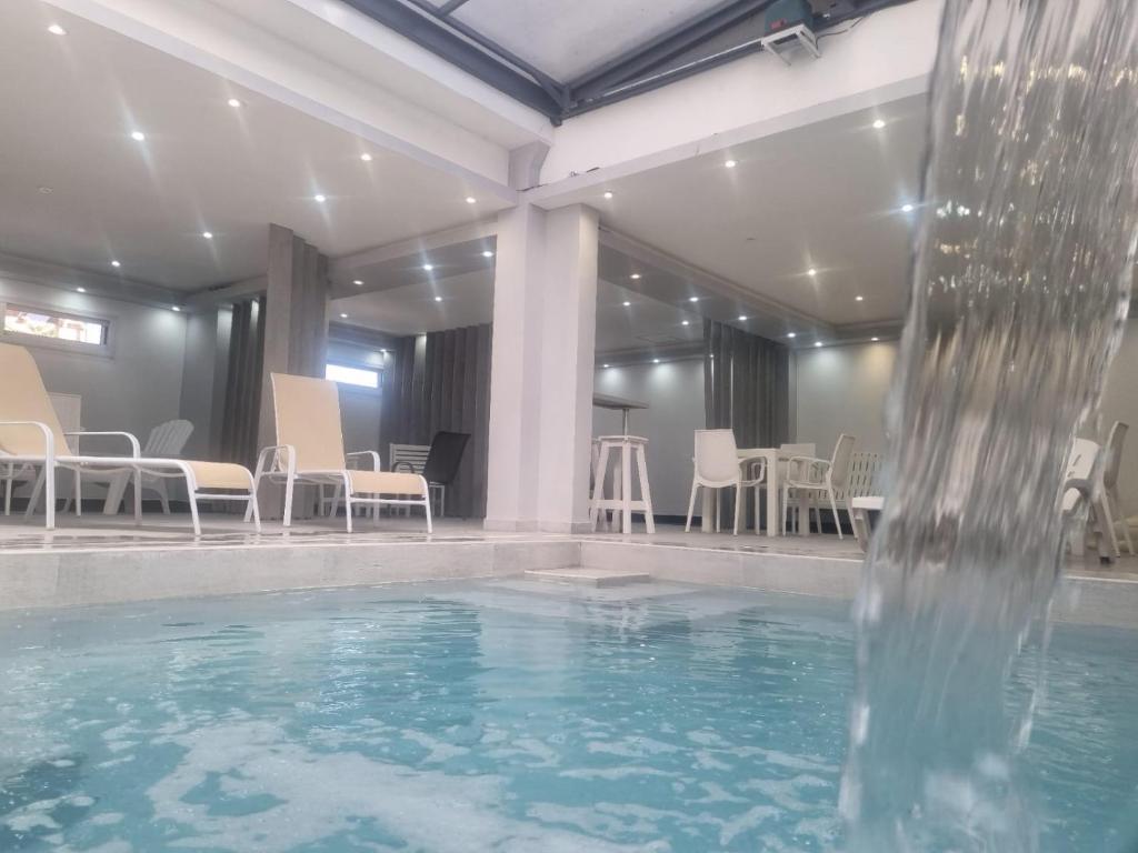 a swimming pool with a water fountain in the middle at Suite La Posta in San Salvador de Jujuy