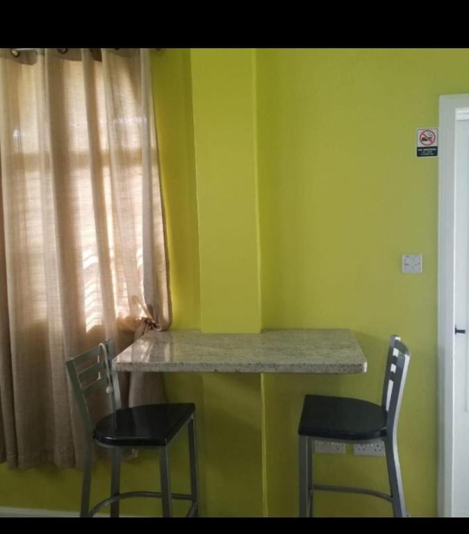 una stanza con due sedie e un tavolo in una stanza di La Bwizan Apt # 2 a Laborie