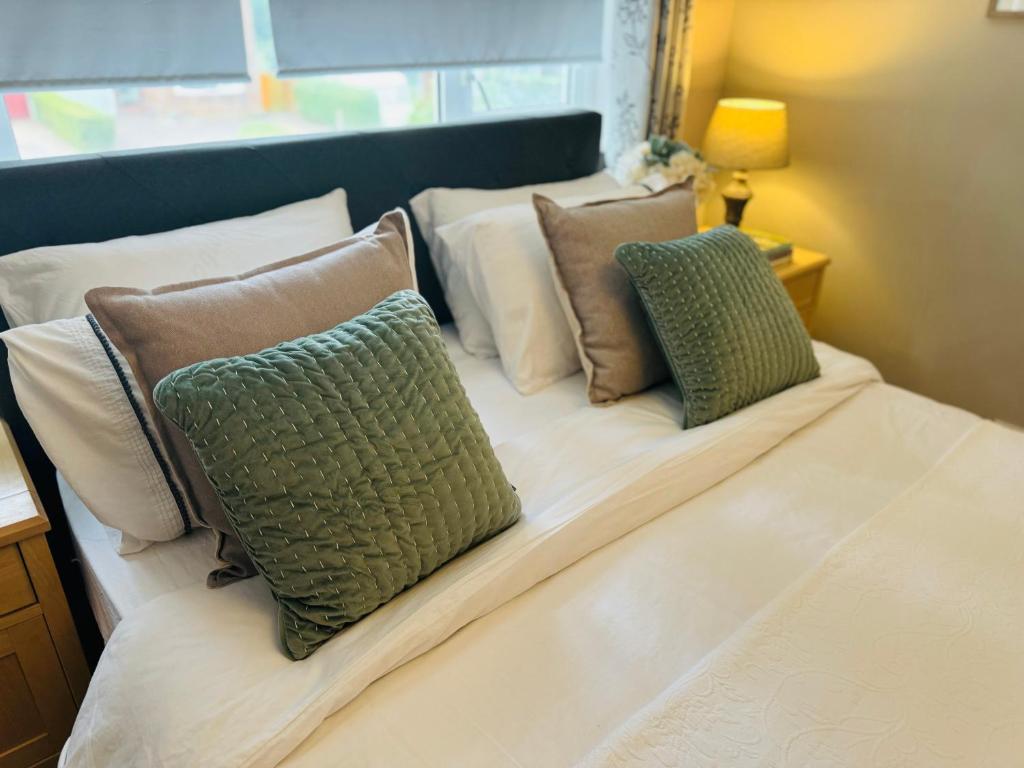 uma cama com três almofadas em cima em Bowershott em Letchworth
