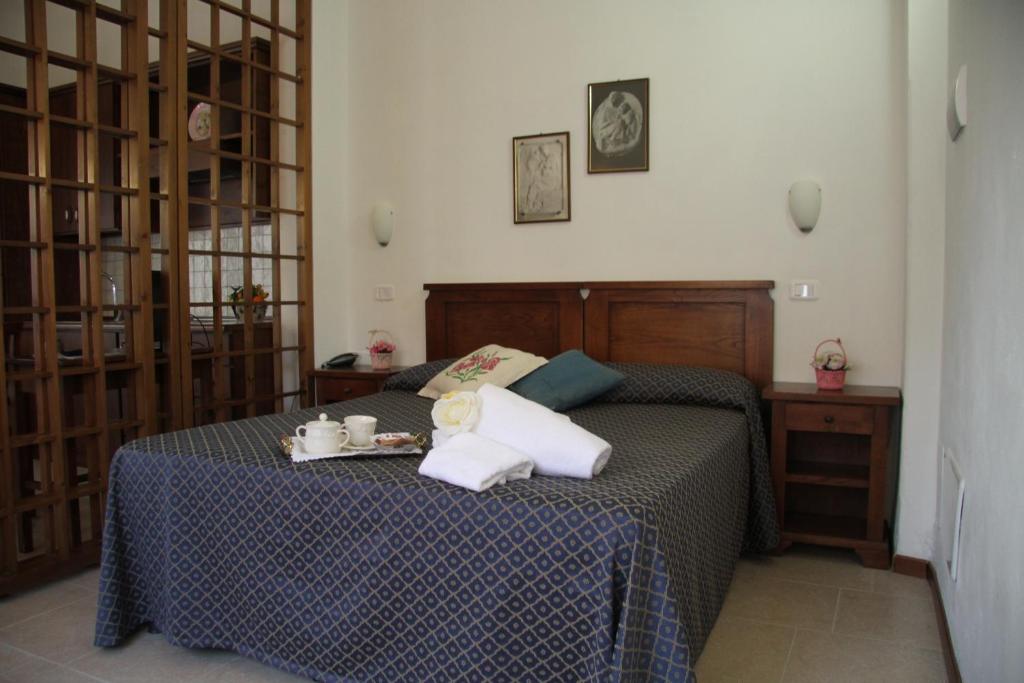 Postel nebo postele na pokoji v ubytování Residence I Due Pini
