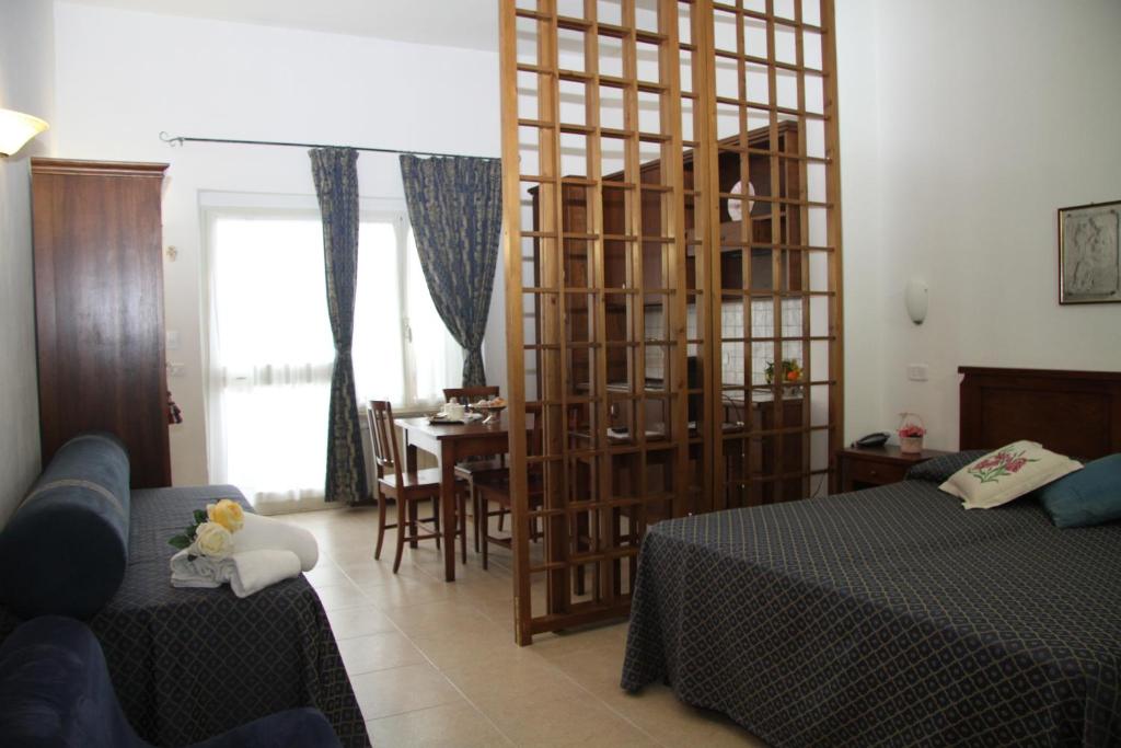 Postel nebo postele na pokoji v ubytování Residence I Due Pini