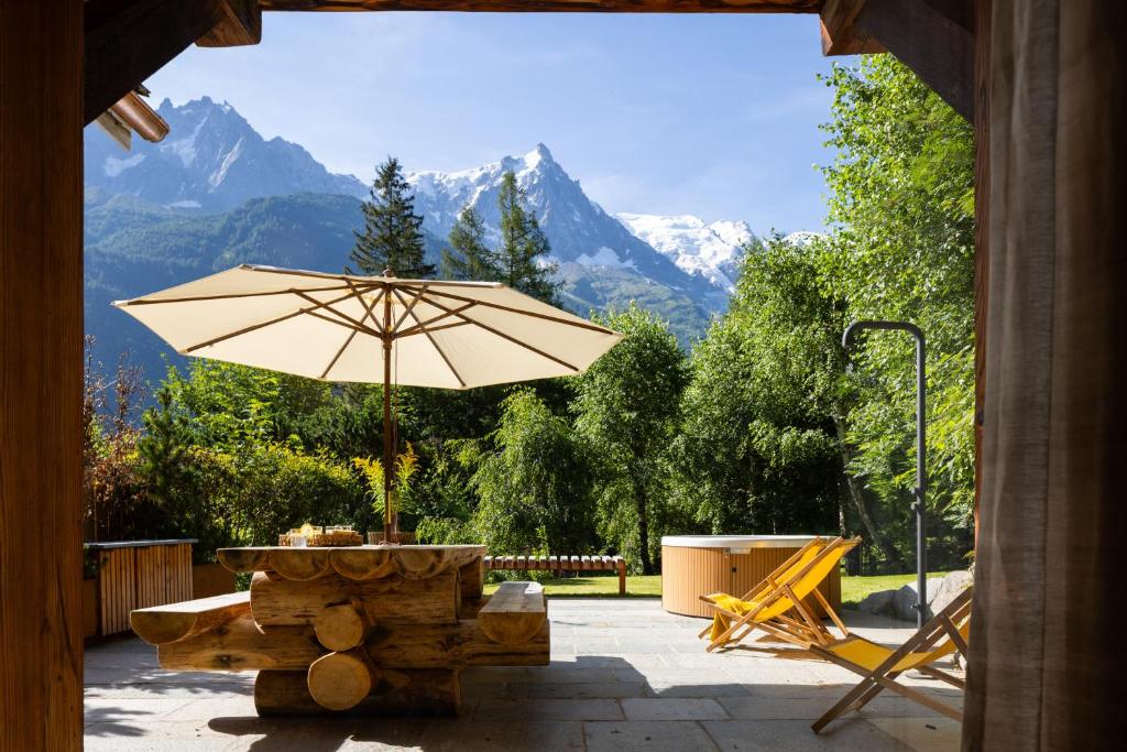 a patio with a table and an umbrella at Three Bedroom Chalet Lemon Pit Chamonix in Chamonix